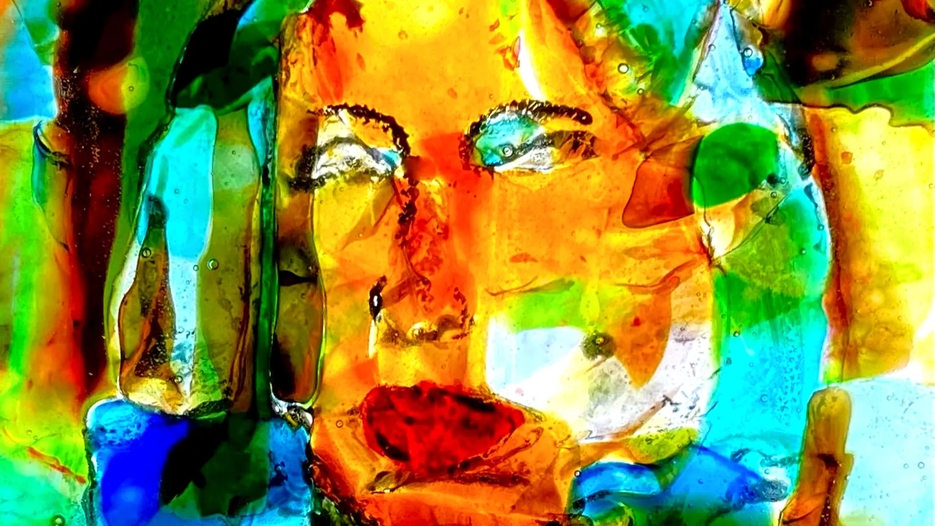 Painted glass panel by Mitch Bedke showing a face in orange, green and blue